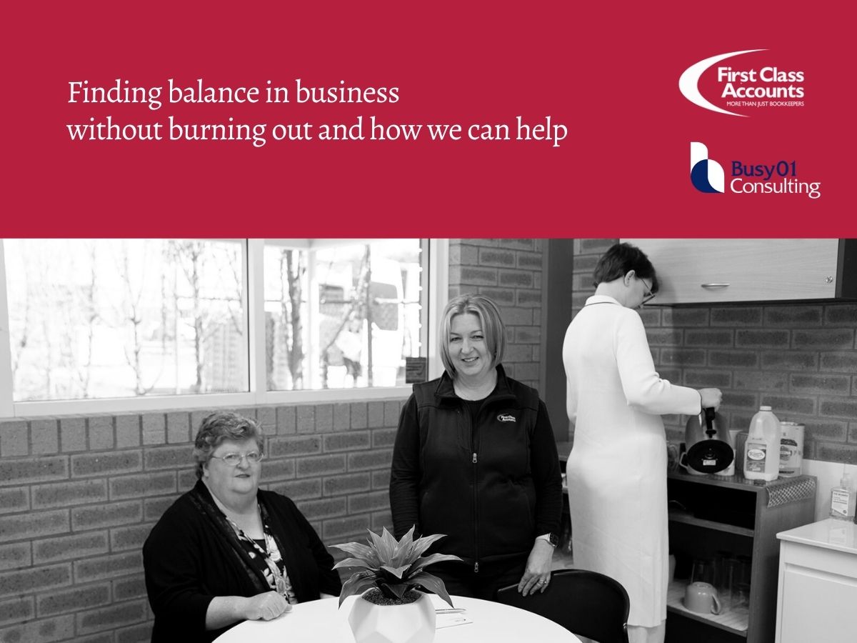 Three women from First Class Accounts Ovens & Murray and Busy01 Consulting in a shared office kitchen area, standing and seated around a table, representing supportive business collaboration and balance