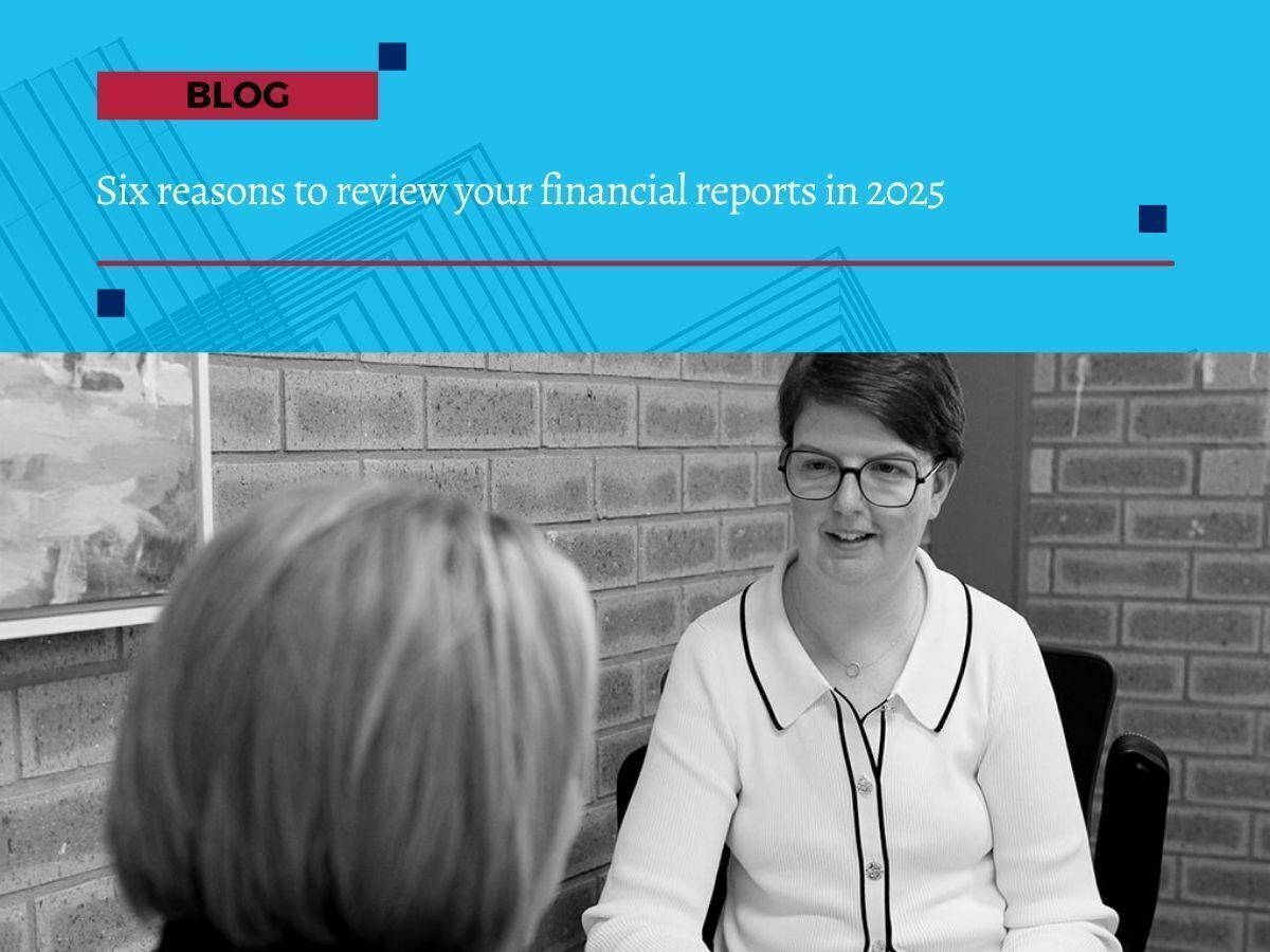 Two women in a business meeting discussing financial reports, with blog banner text reading ‘Six reasons to review your financial reports in 2025’.