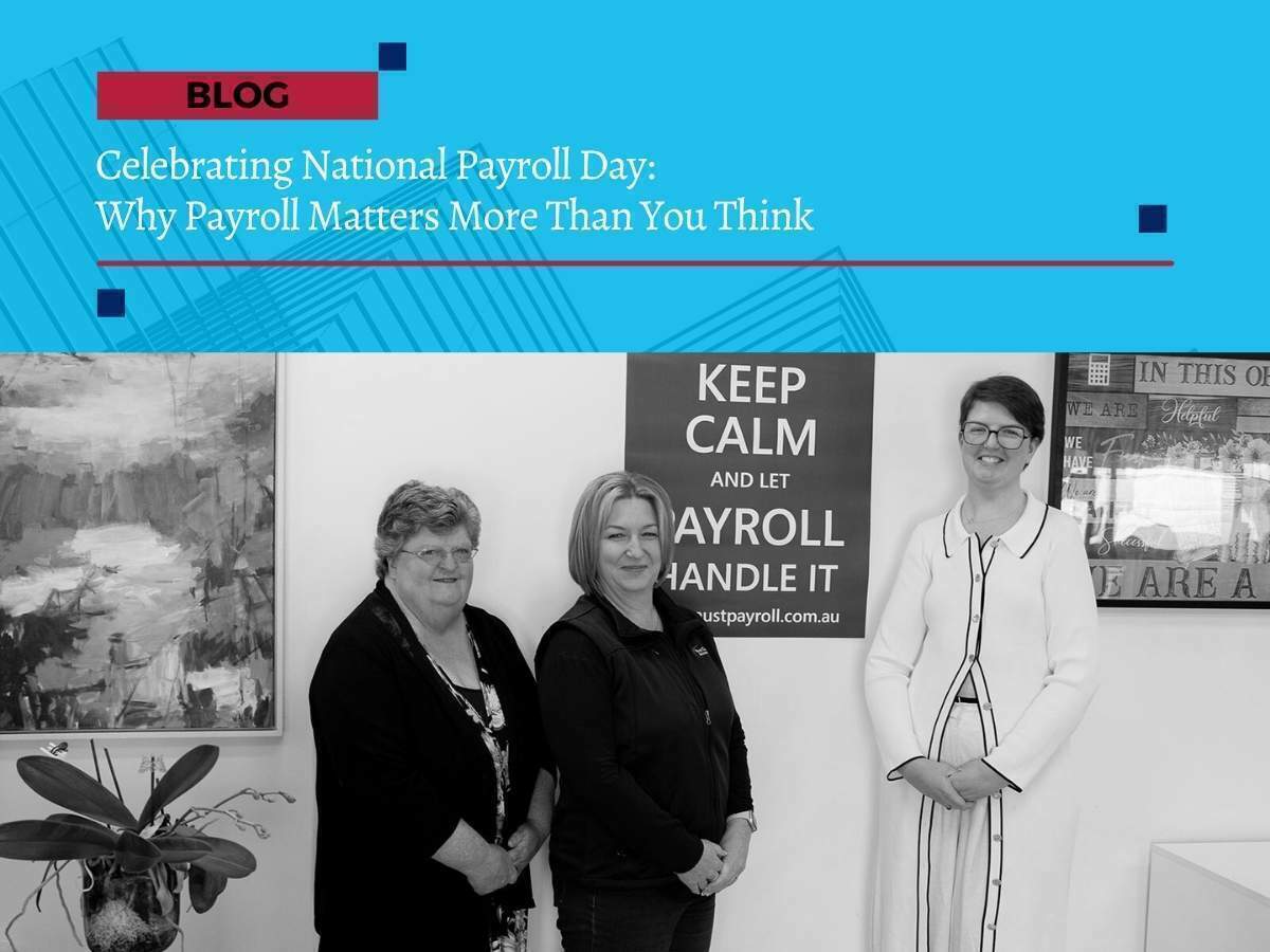 Three payroll professionals from First Class Accounts Ovens & Murray standing together in front of a “Keep Calm and Let Payroll Handle It” sign, celebrating National Payroll Day.