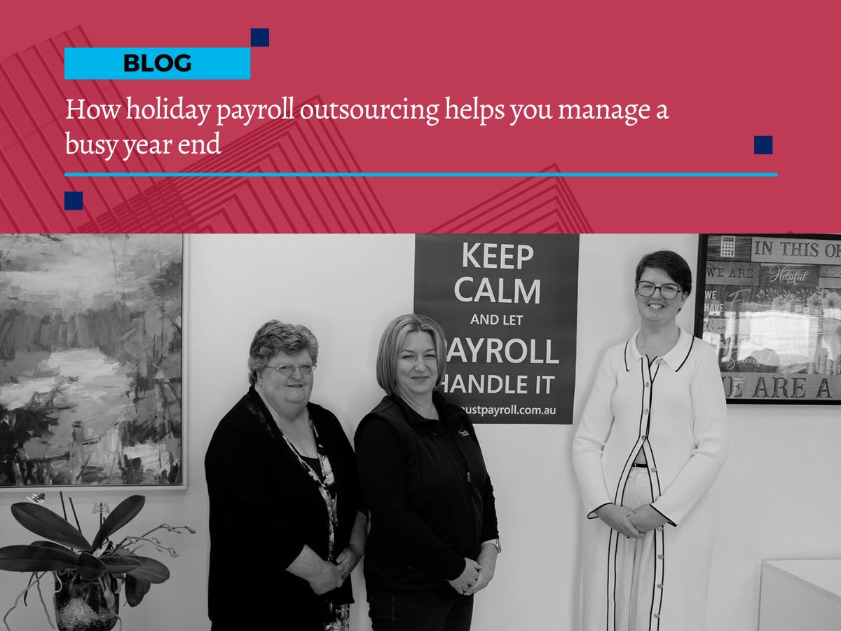 Three women standing in an office beside a sign that reads “Keep calm and let payroll handle it,” with the First Class Accounts Ovens & Murray blog title banner displayed above.